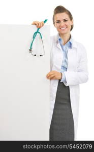 Happy doctor woman with stethoscope showing blank billboard