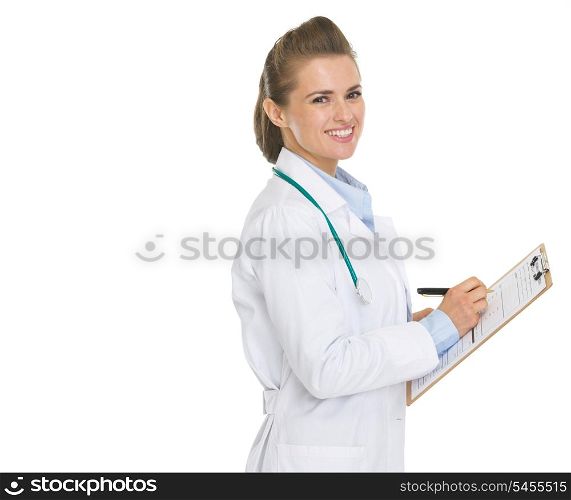 Happy doctor woman writing in clipboard