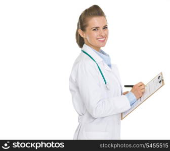 Happy doctor woman writing in clipboard