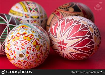 happy easter card. beautiful Easter egg Pysanka handmade - ukrainian traditional on a red background