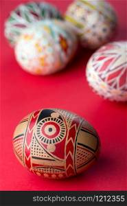 happy easter card. beautiful Easter egg Pysanka handmade - ukrainian traditional on a red background