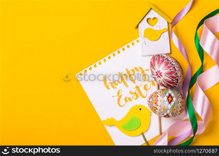 happy easter card. beautiful Easter egg Pysanka handmade - ukrainian traditional on a yellow background