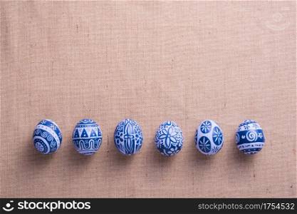 Happy Easter day eggs on brown cloth background with copy space.