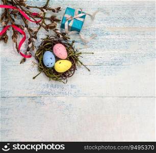 Happy Easter. Easter eggs in the nest. Willow twigs. Holy Easter. Blue turquoise background. Gift boxes with ribbons.. Gift boxes with ribbons. Happy Easter. Willow twigs. Holy Easter. Blue turquoise background. Easter eggs in the nest.