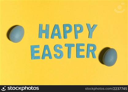 happy easter inscription with colourful eggs table