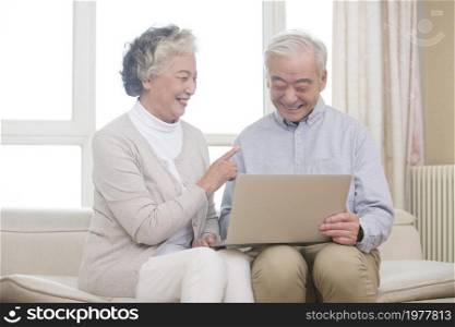 Happy elderly couples using a tablet computer