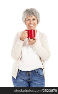 Happy elderly woman holding and drinking a cup of coffee