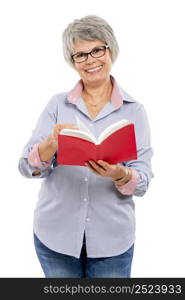 Happy elderly woman holding and reading a book