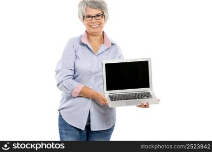 Happy elderly woman holding and showing something on a laptop