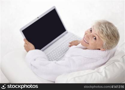 Happy elderly woman with a laptop