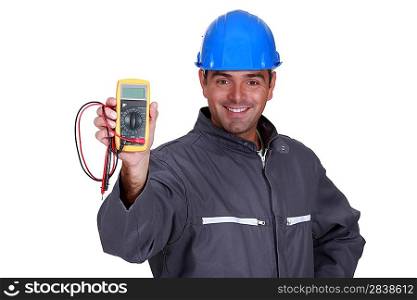 happy electrician showing multimeter