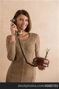 Happy elegant woman talking on retro telephone
