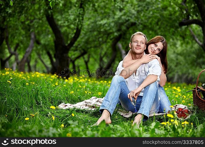 Happy embracing couple in park in the foreground