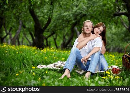 Happy embracing couple in park in the foreground