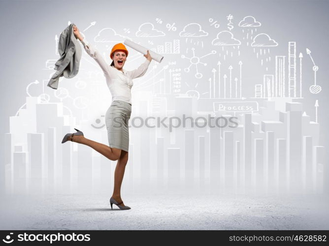 Happy engineer. Young woman engineer in helmet jumping joyfully