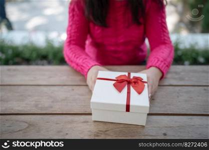 Happy excited asian woman hands holding Christmas gift box. cheerful girl packing Xmas present or open box xmas new year birthday gift.