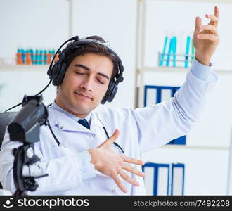 Happy excited doctor listening to music during lunch break in hospital. Happy excited doctor listening to music during lunch break in ho