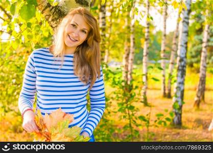 happy expectant mother walks in autumn park