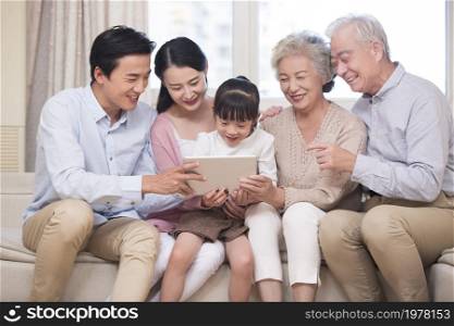 Happy families using a tablet computer together