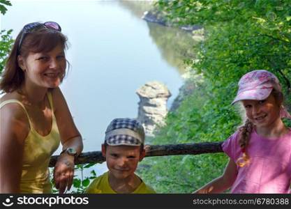 Happy family and Bakota spring view behind ( Khmelnytskyi Oblast, Ukraine)