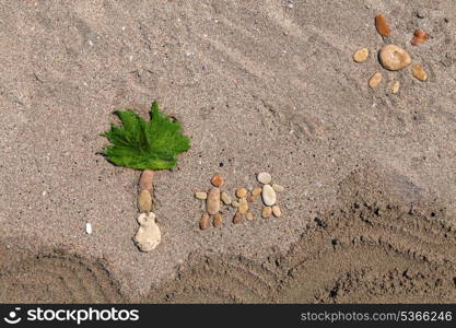 Happy family and palm tree made from stone on the sand beach&#xA;