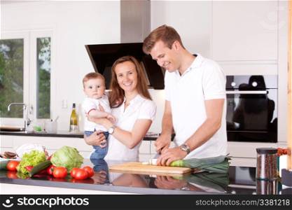 Happy family at home in the kitchen cooking, making a meal