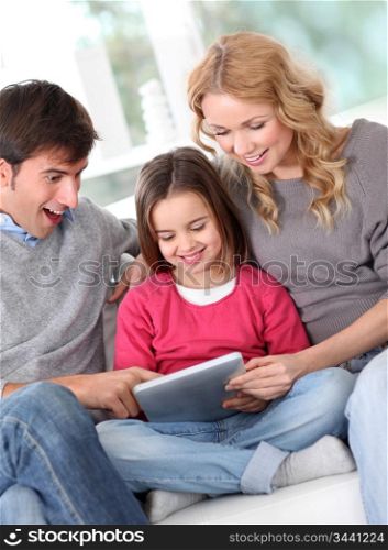 Happy family at home using electronic tablet
