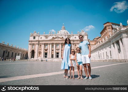 Happy family at St. Peter’s Basilica church in Vatican city. Travel parents and kids on european vacation in Italy.. Happy family at St. Peter’s Basilica church in Vatican city.