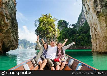 Happy family boat trip on summer vacation in Ratchaprapha Dam, Khao Sok National Park, Surat Thani Province, Thailand ( Guilin of Thailand )&#xA;