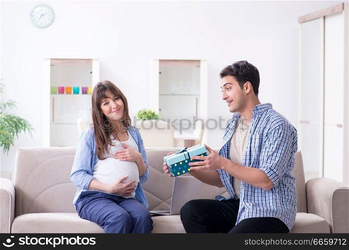 Happy family celebrating pregnancy at home