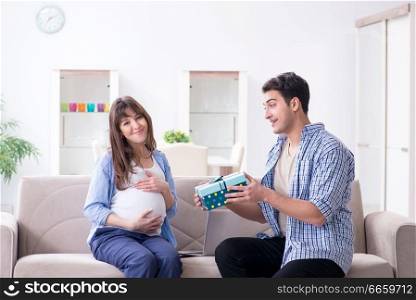 Happy family celebrating pregnancy at home