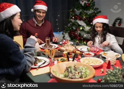 happy family celebrating together at christmas day night in dining room that decorated with christmas tree for christmas festival day, happy family lovely lifestyle concept
