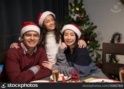 happy family celebrating together at christmas day night in dining room that decorated with christmas tree for christmas festival day, happy family lovely lifestyle concept