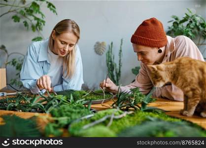 Happy family couple decorator working on floral composition at cozy workshop art studio. Happy family couple decorator working on floral composition at workshop