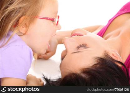 Happy family, cute little girl child playing with mom together doing fun. Daughter and mother embracing isolated on white