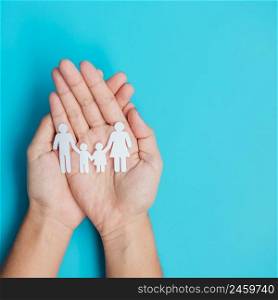 Happy Family day. hands holding paper shape cutout with Father, Mother and Children. international day of families, Warm home, Homeless, Foster, Insurance, Charity and Donation concepts.
