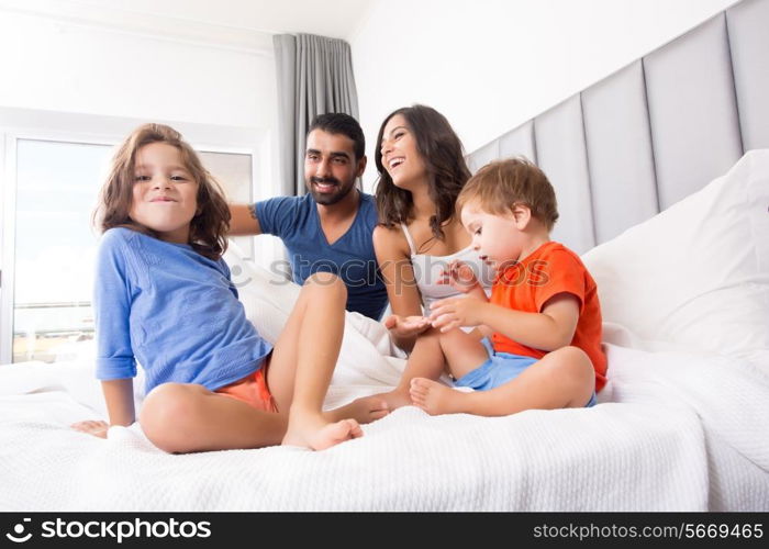 Happy family enjoying the morning in bed
