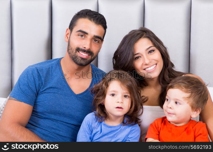 Happy family enjoying the morning in bed