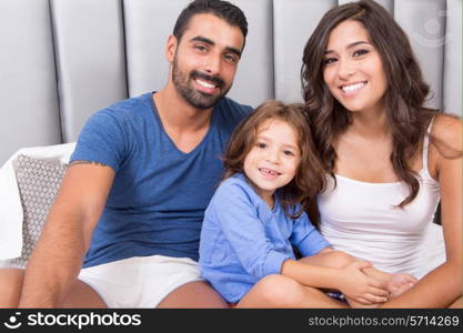 Happy family enjoying the morning in bed