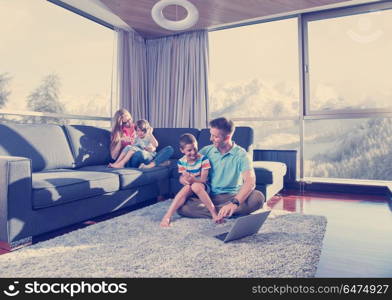 Happy family. Father, mother and children playing a video game Father and son playing video games together on the floor. Happy family playing a video game