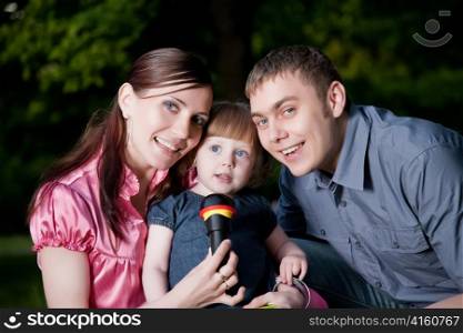 Happy Family. Father, Mother And Daugther In The Park