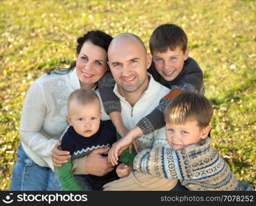 Happy family, father, mother and four sons photo in nature