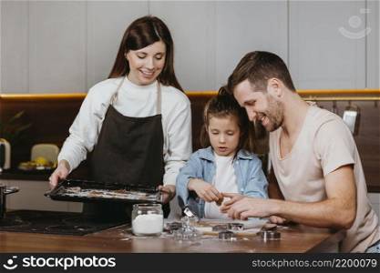 happy family father mother with daughter cooking together