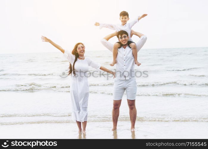 Happy family goes vacation on the beach in summer.