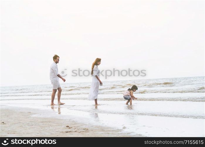Happy family goes vacation on the beach in summer.