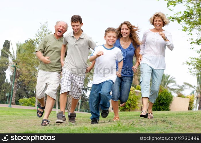 Happy family. Grandfather, grandmother, and brothers enjoying outdoors and having fun