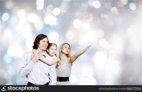 Happy family. Happy family of mother father and daughter against bokeh background
