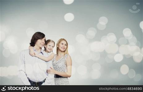 Happy family. Happy family of mother father and daughter against bokeh background