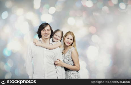 Happy family. Happy family of mother father and daughter against bokeh background