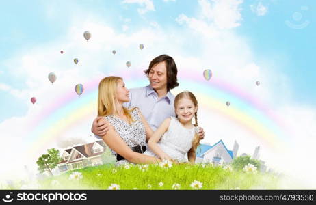 Happy family. Happy family of mother father and daughter sitting on grass